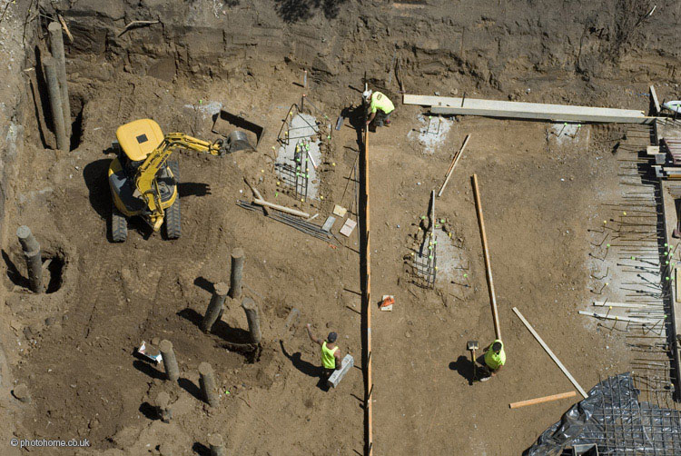 viewed from above, workers on a building site